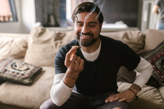 person smoking marijuana and smiling